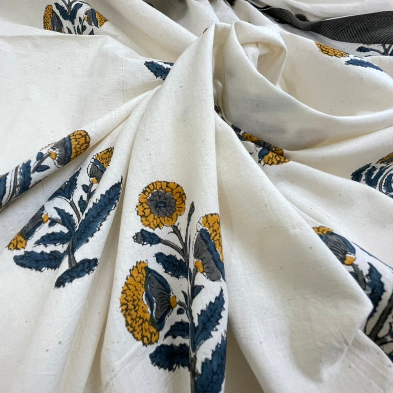 Close-up of white fabric with blue and yellow floral patterns