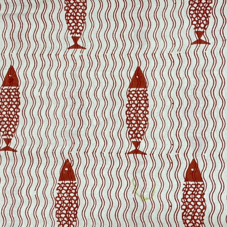 Patterned fabric with red fish design on a light background
