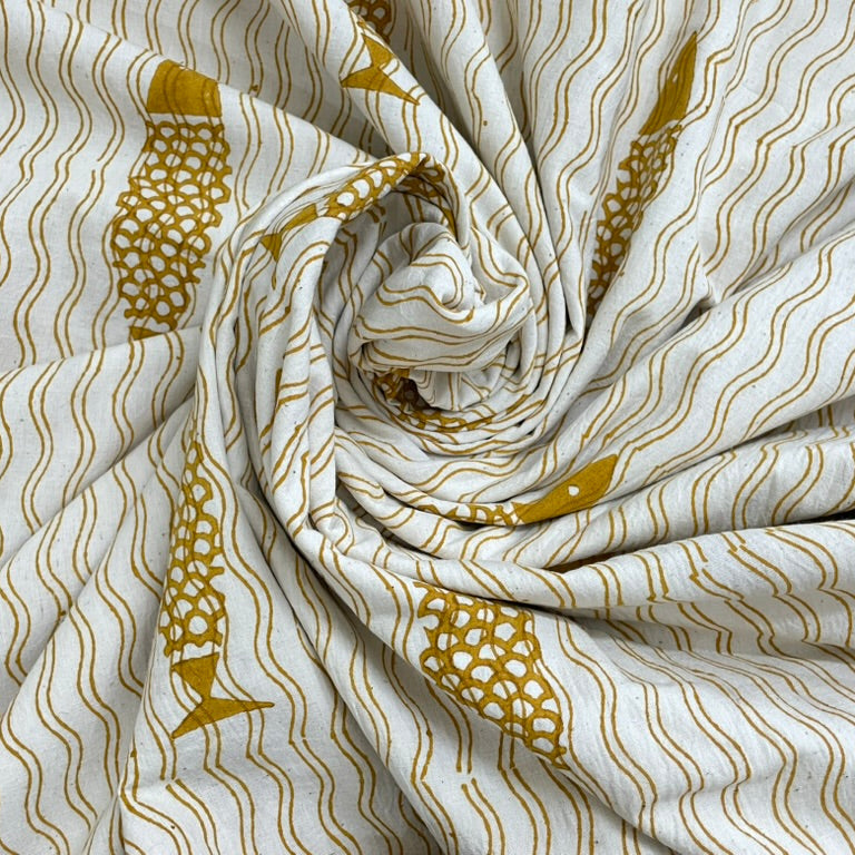 Roll of fabric with gold and white pattern