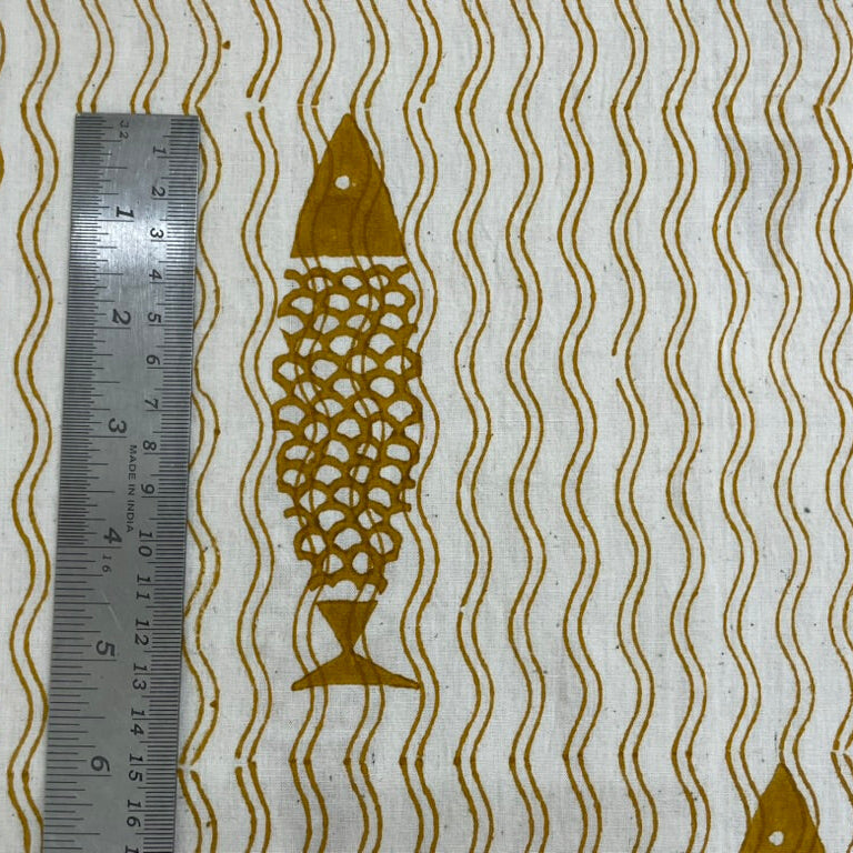 Fabric with fish and wavy line pattern, ruler for scale