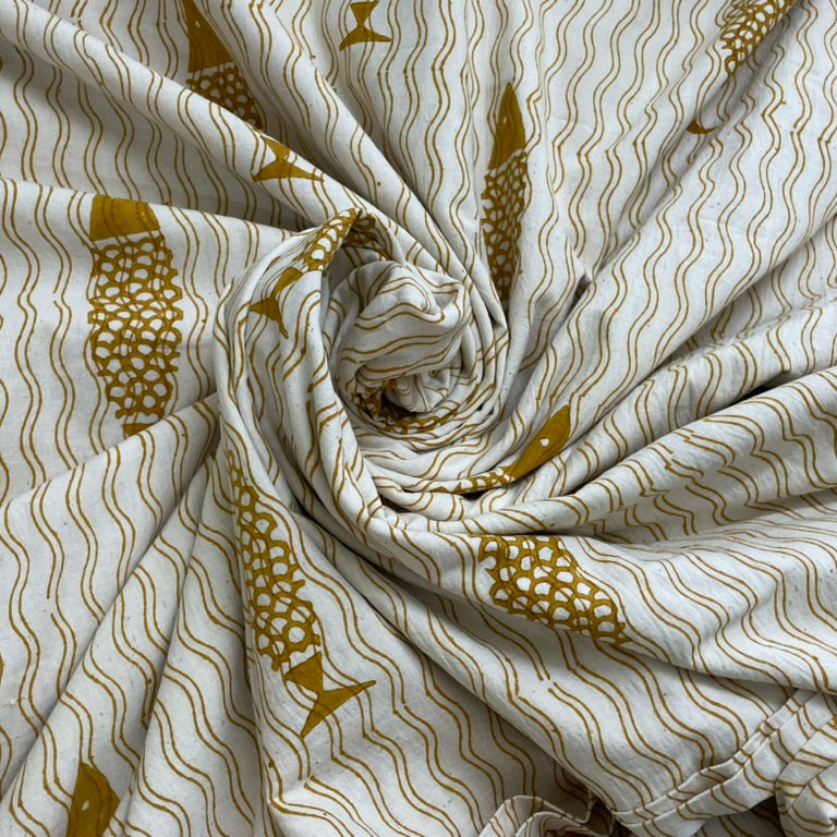 Fabric with gold fish and wave pattern on a white background