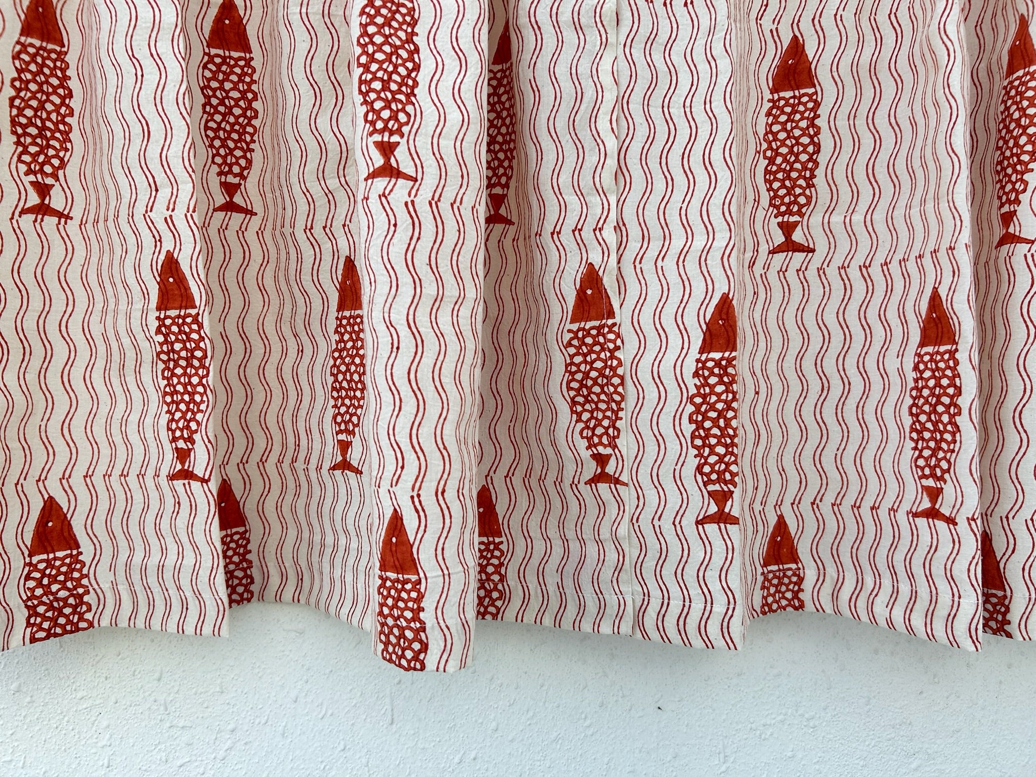Curtain with red fish pattern on a white background