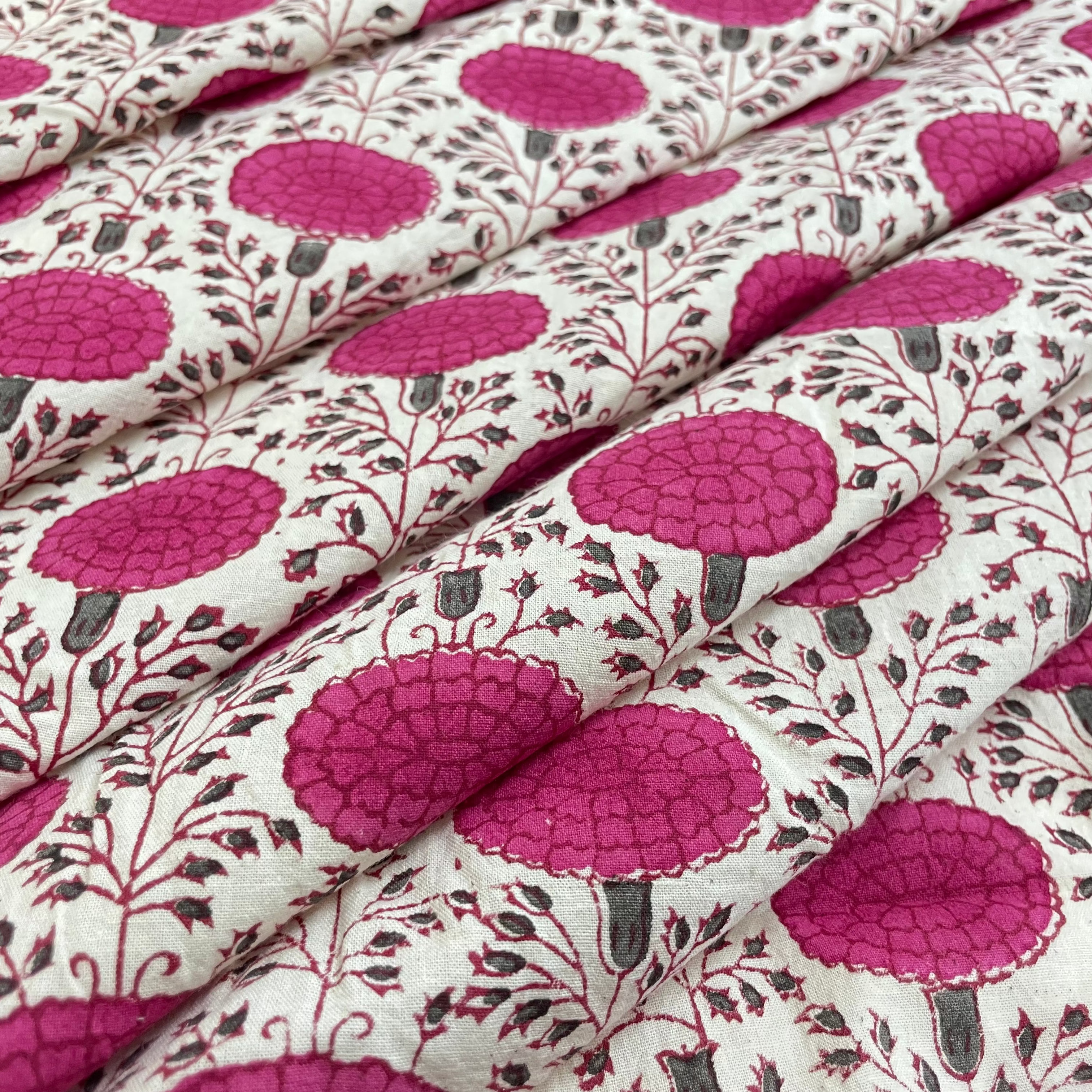 Close-up of fabric with pink floral pattern on a white background