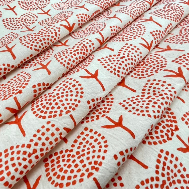 Fabric with orange floral pattern on white background