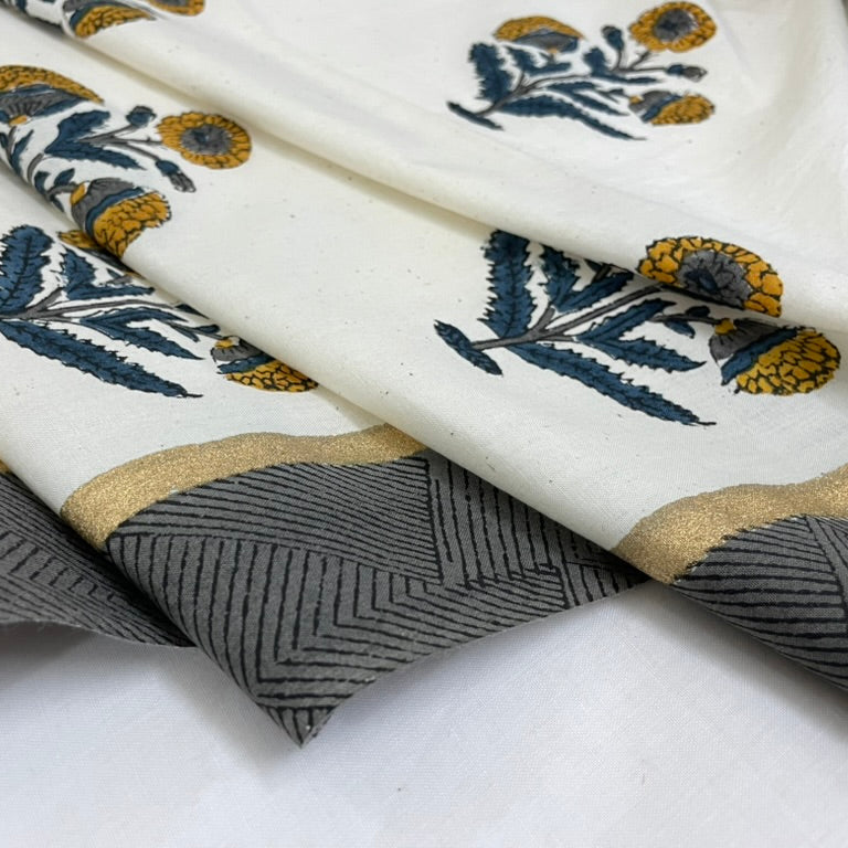 Close-up of fabric with floral and geometric patterns on a white background