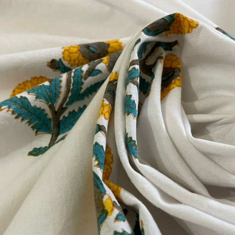 Close-up of white fabric with green and yellow floral patterns