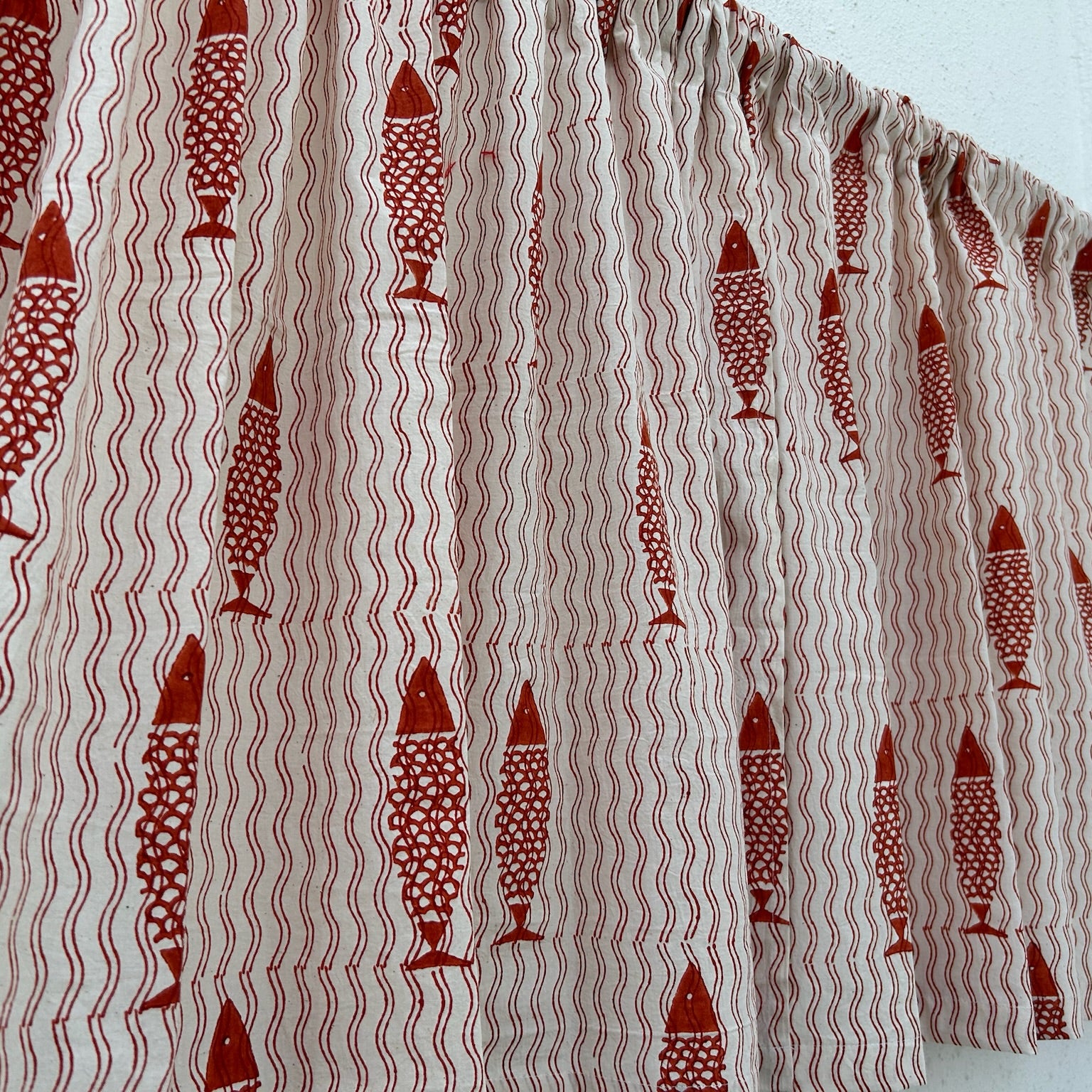 Fabric with red fish pattern on a white background