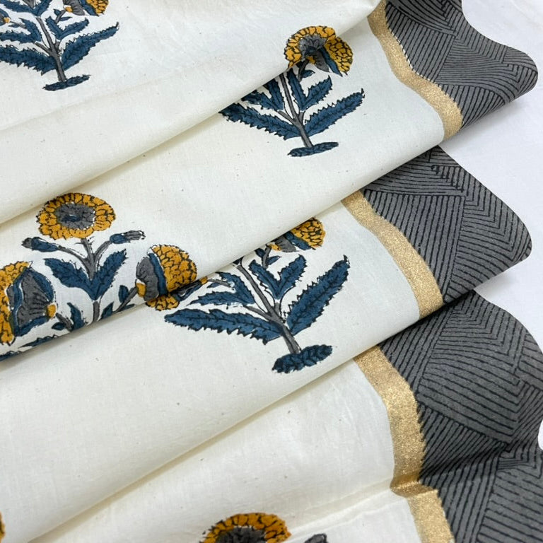 Rolls of fabric with floral patterns and a textured gray fabric.