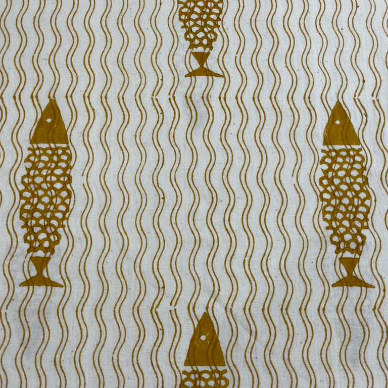 Patterned fabric with gold fish and wavy lines on a light background