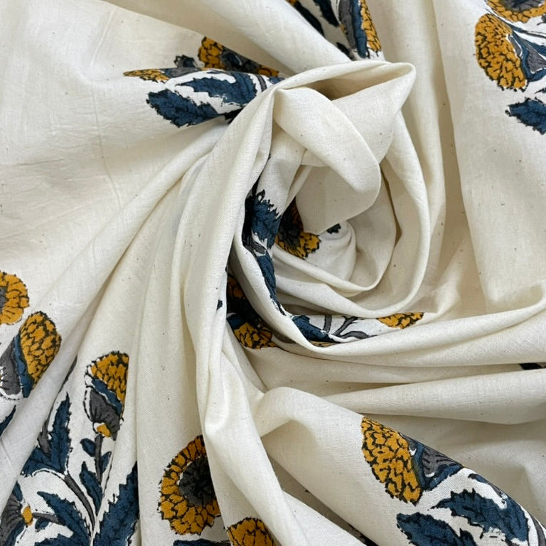 Close-up of white fabric with blue and yellow floral patterns
