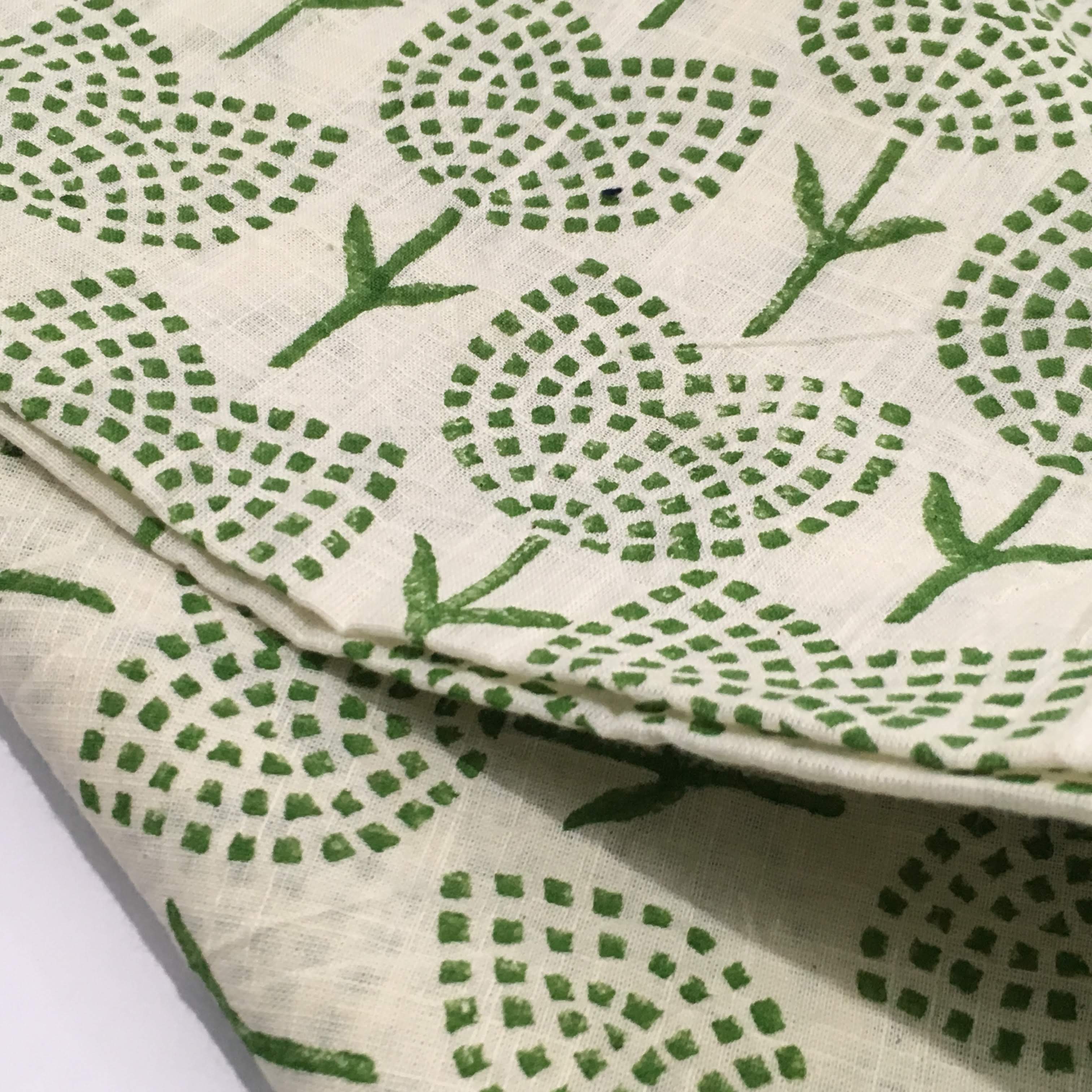 Green leaf pattern on white fabric