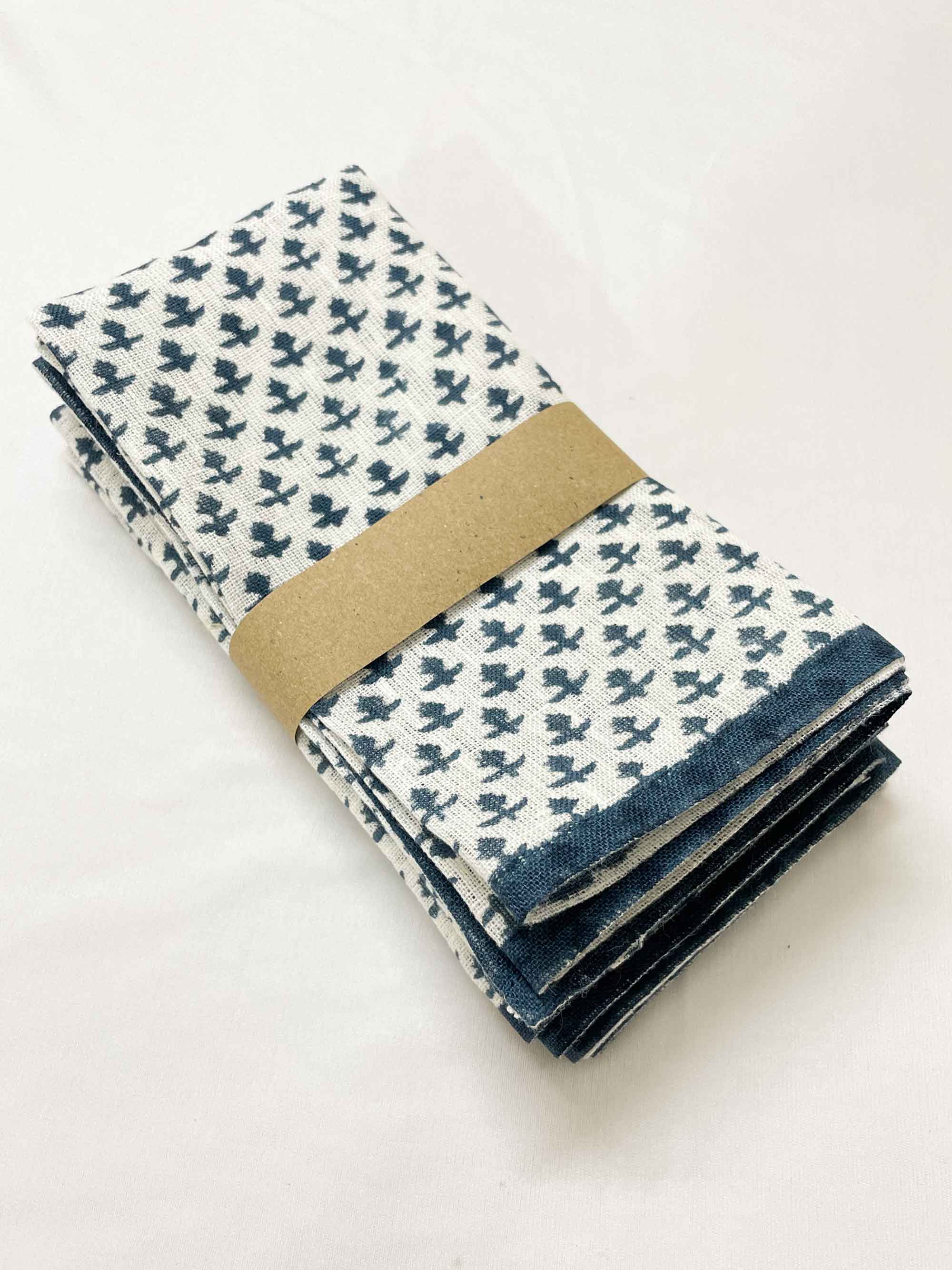 Stack of four eco-friendly linen napkins featuring cobalt blue hand block prints, durable sustainable table linens