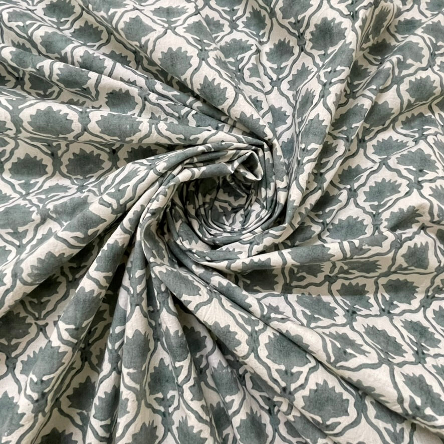 Roll of patterned fabric with geometric design in gray and white