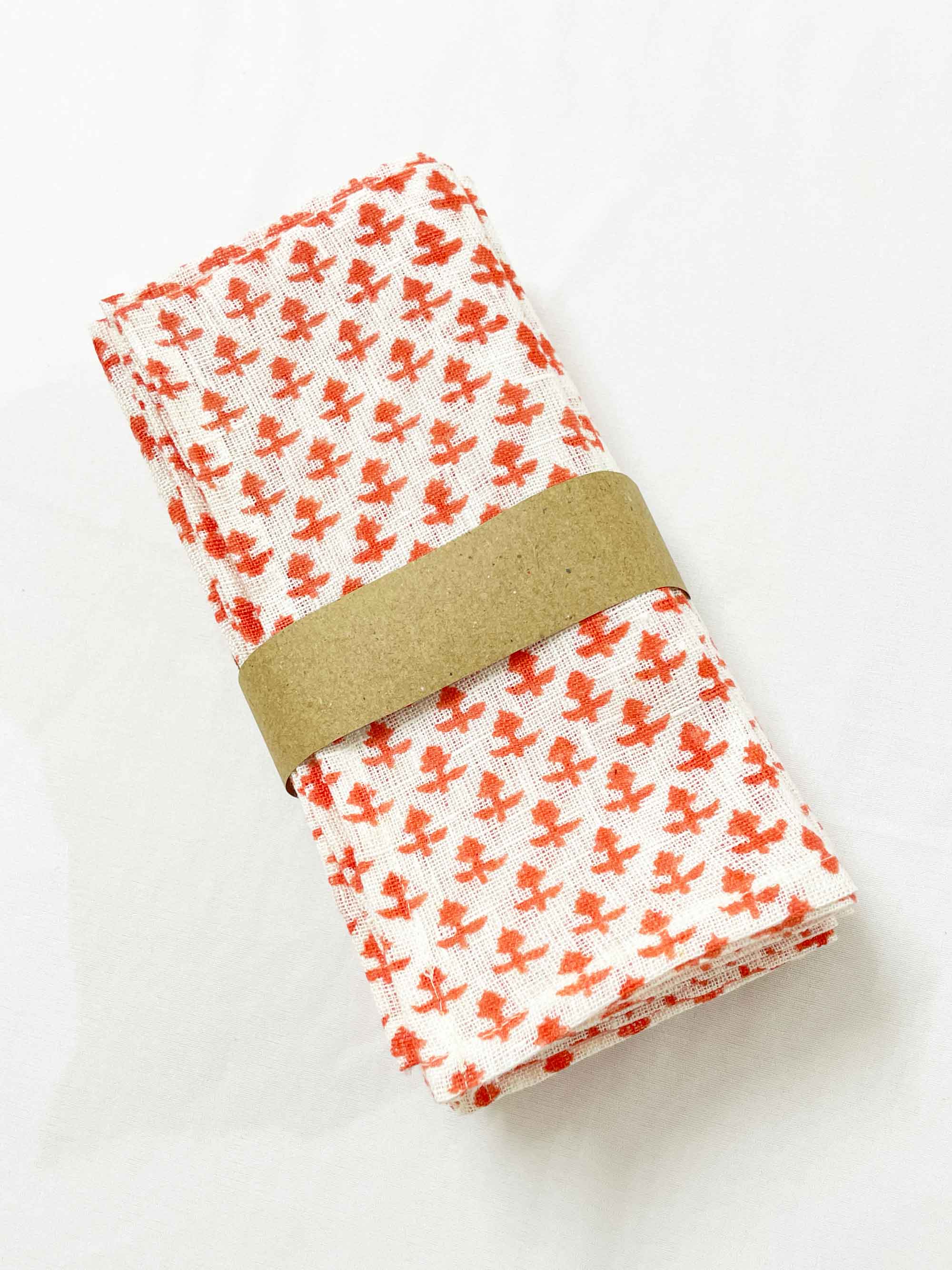 Set of four pure linen dinner napkins hand block printed in pink on off-white fabric