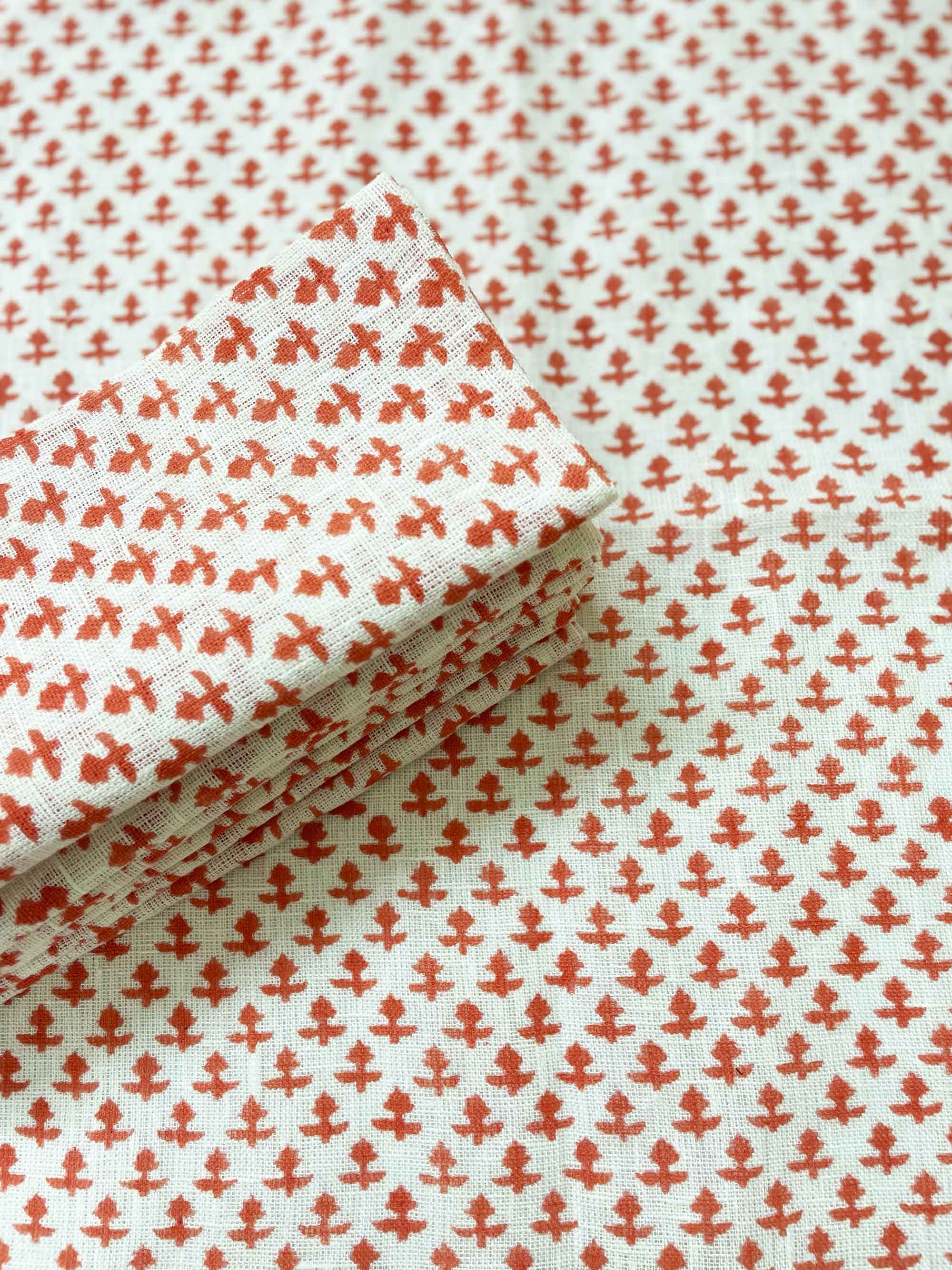 Pink hand block printed floral design on soft off-white pure linen napkin