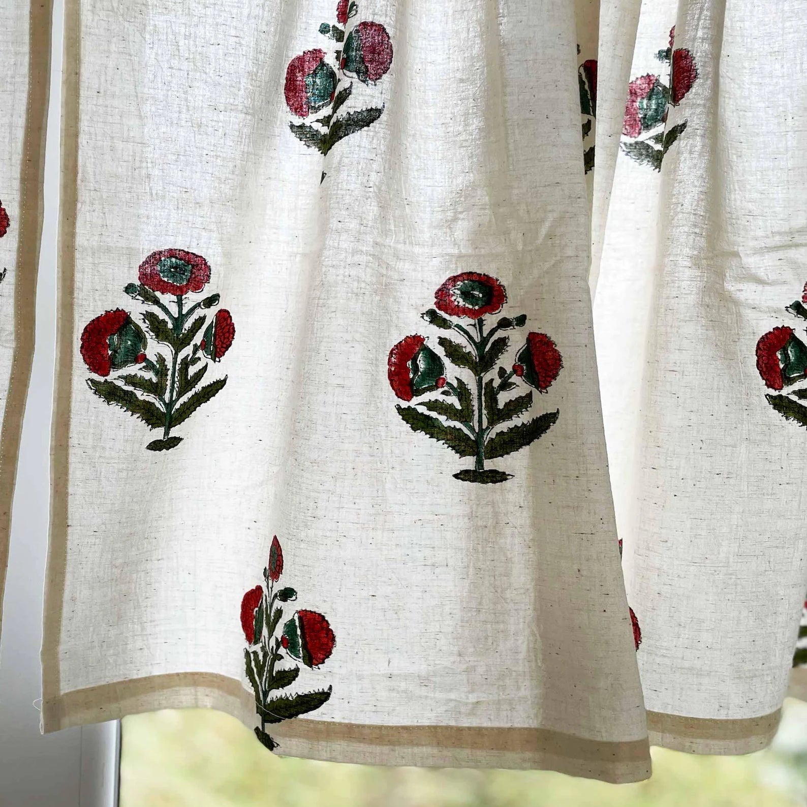 Hand block printed cotton café curtain with rust and green poppy floral pattern for kitchen window.