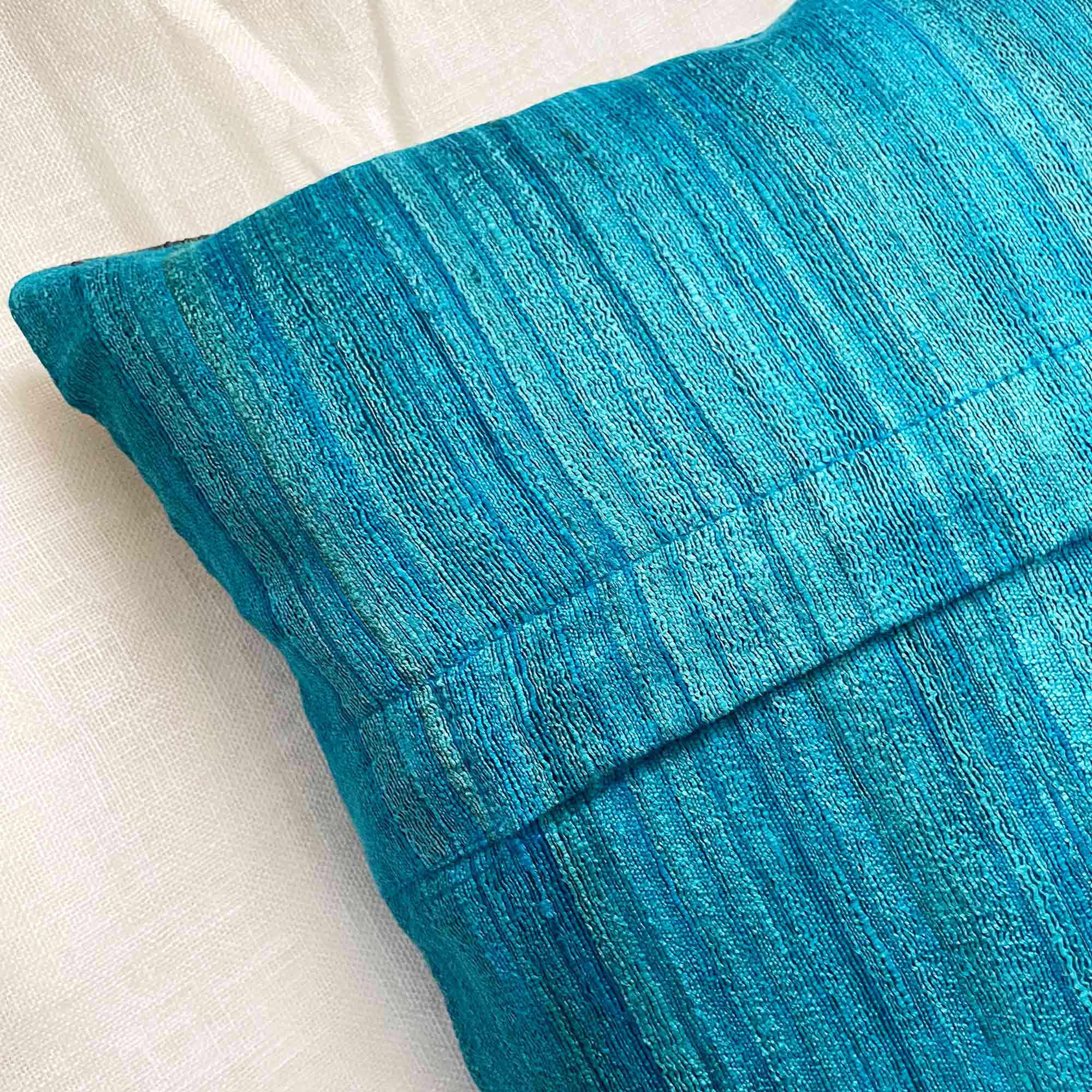 Grey and teal colorblock silk pillow cover with a modern handcrafted look and smooth woven texture.