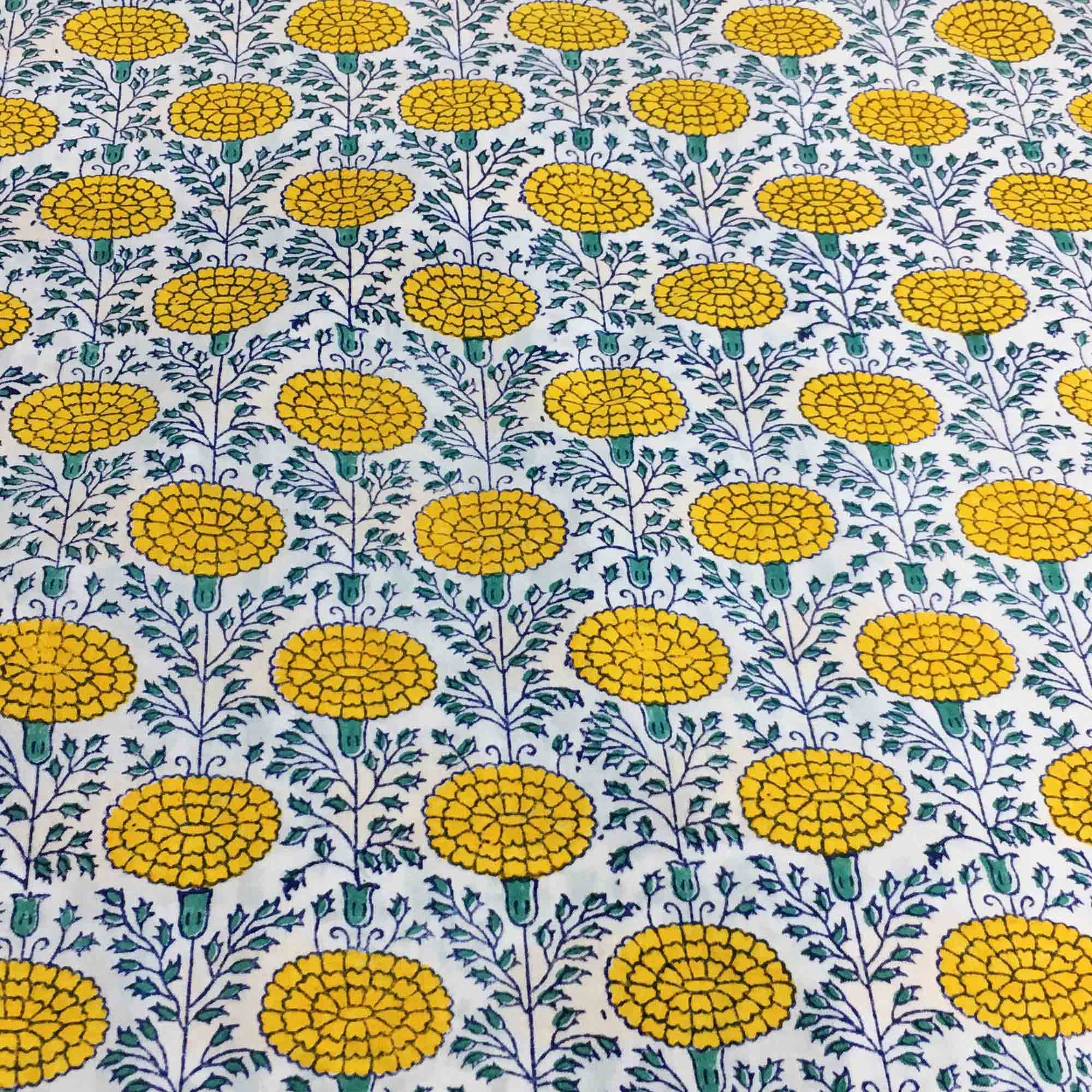 Patterned fabric with yellow floral design on a white background