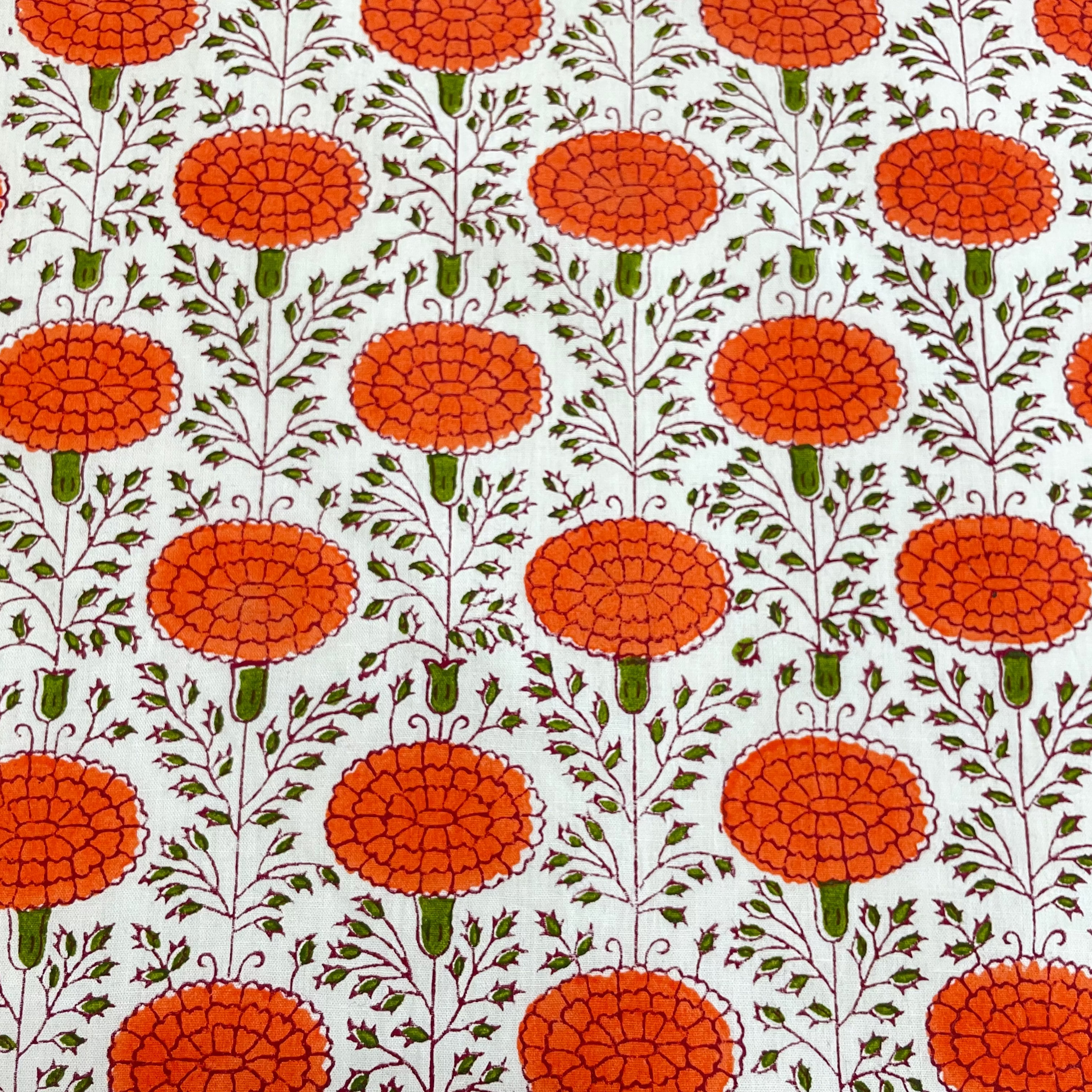 Patterned fabric with orange floral design on a white background