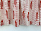 Curtain with red fish pattern on a white background
