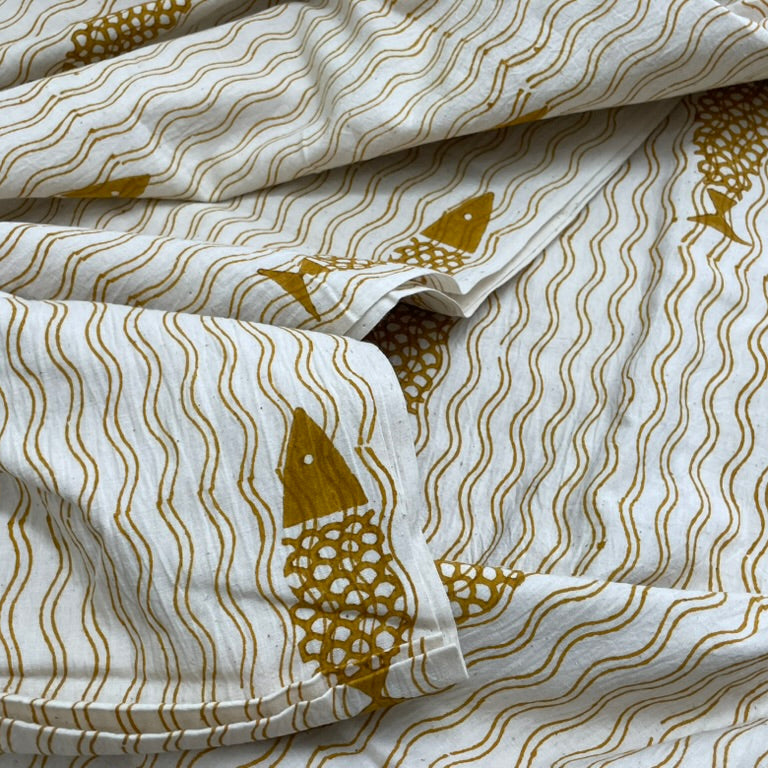Folded fabric with gold patterns on a white background
