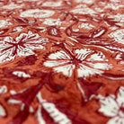 Close-up of a floral patterned fabric with brown and white colors.