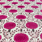 Fabric with a pattern of pink floral designs on a white background