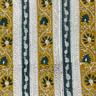 Patterned fabric with black, gold, and white design on a striped background