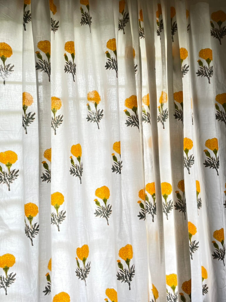 Curtain with yellow floral pattern on a white background