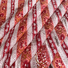 A close-up of draped fabric with a Rust and mustard color