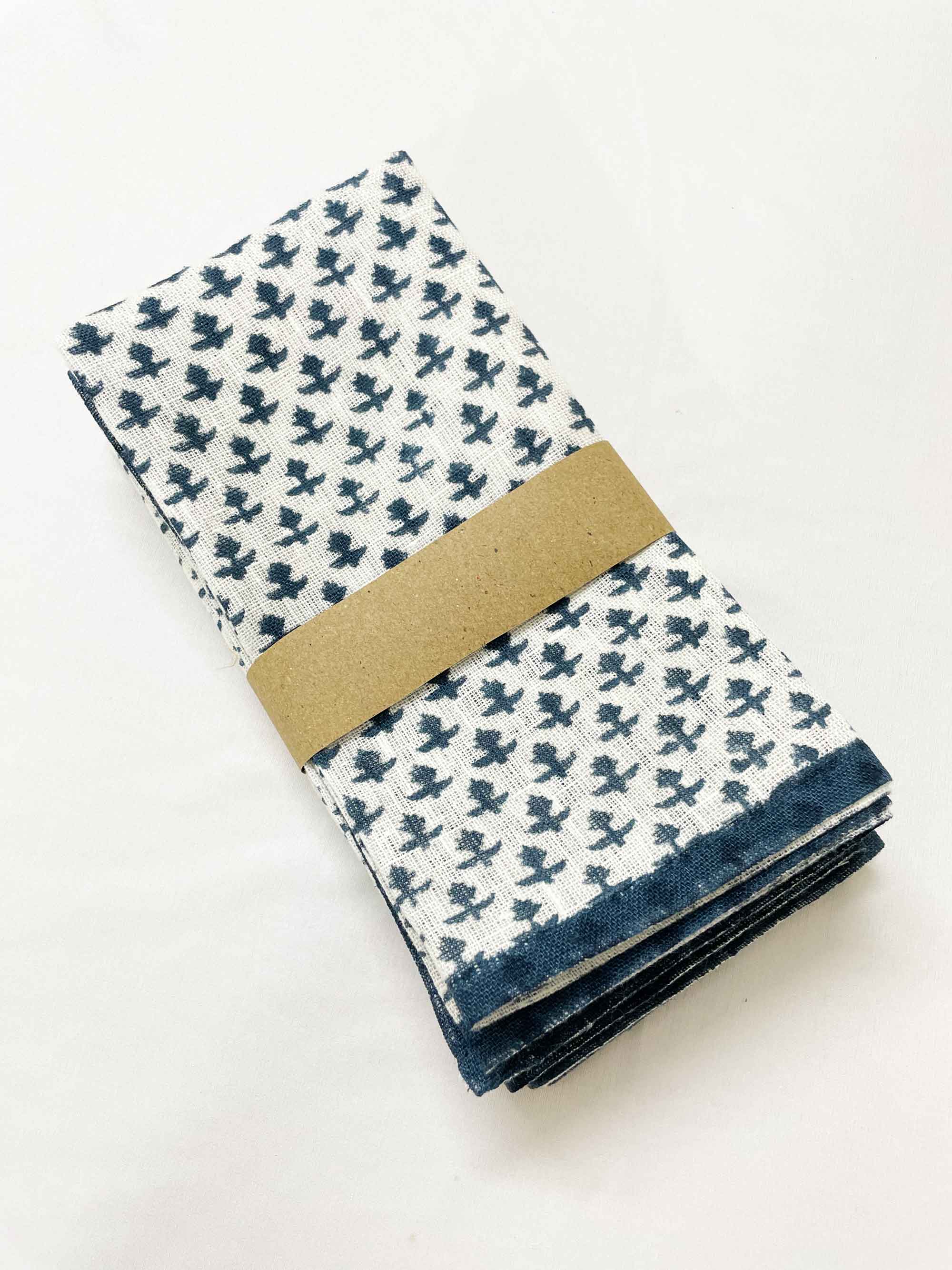 Set of four sustainable pure linen dinner napkins, hand block printed in cobalt blue on off-white fabric, perfect eco-friendly table linens