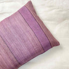 Purple pillow with a textured pattern on a white background
