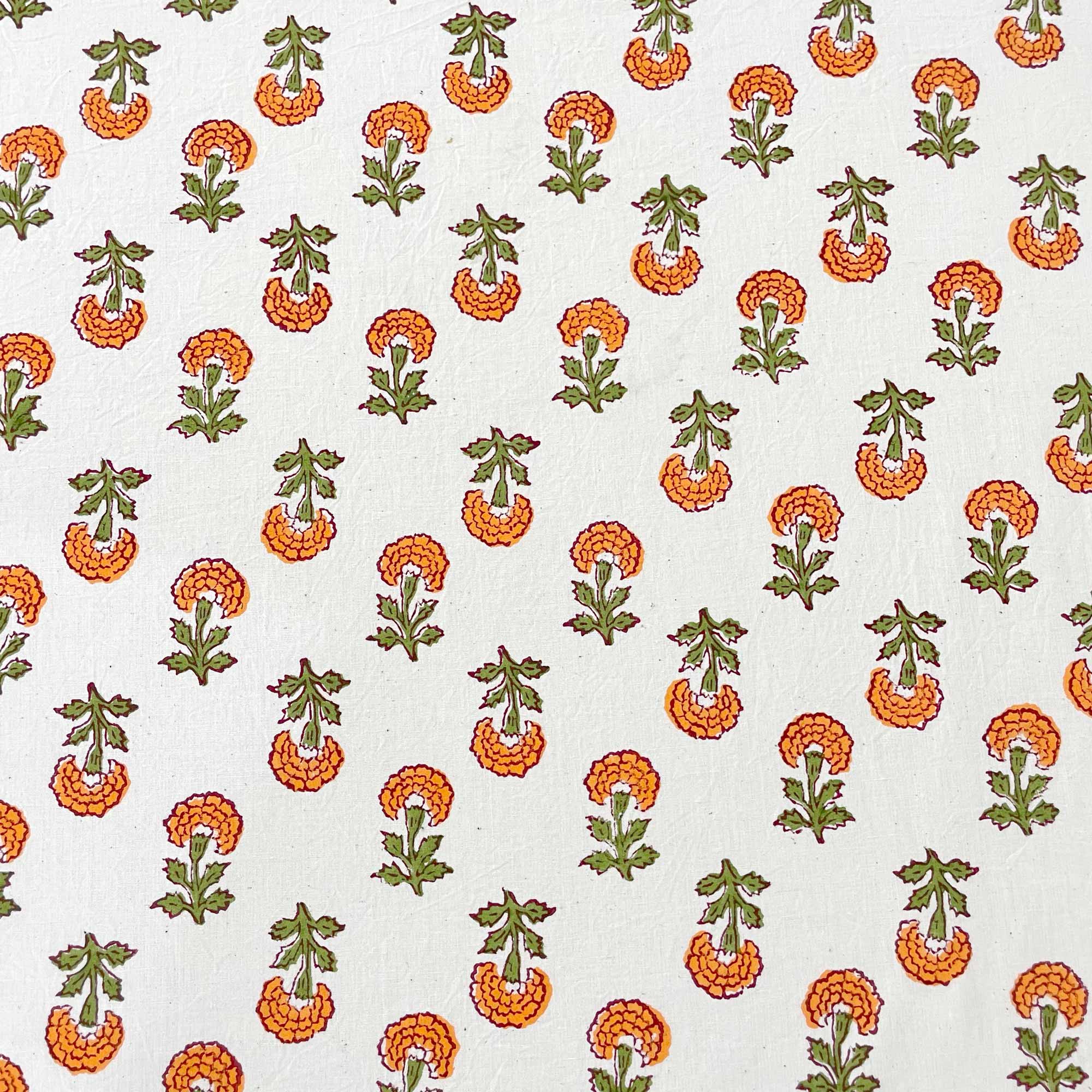 A fabric featuring a repeating pattern of marigold flowers in shades of orange and green on a cream background.