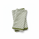 Set of three folded green and white patterned towels on a white background
