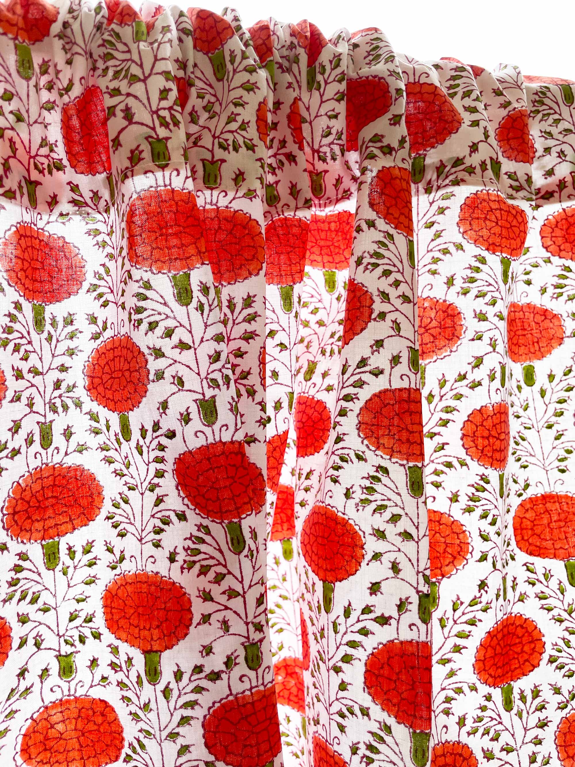 Close-up of a fabric with red floral pattern on a white background