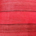 Close-up of red striped tussar silk pillow cover highlighting fine handloom stripes and organic silk slubs.