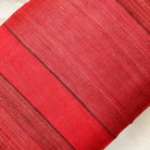 Red tussar silk pillow cover with linear stripe pattern, artisanal finish, and rich natural silk texture.