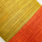 Close up of tussar silk pillow cover highlighting natural slubs and bold colorblock design.
