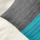 Grey and teal colorblock silk pillow cover featuring bold striped design and artisanal woven texture.