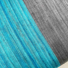 Close-up of grey and teal silk stripe pillow cover highlighting fine weave, color contrast, and silk texture.