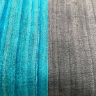 Styled grey and teal colorblock silk pillow cover suited for modern and minimalist interiors.