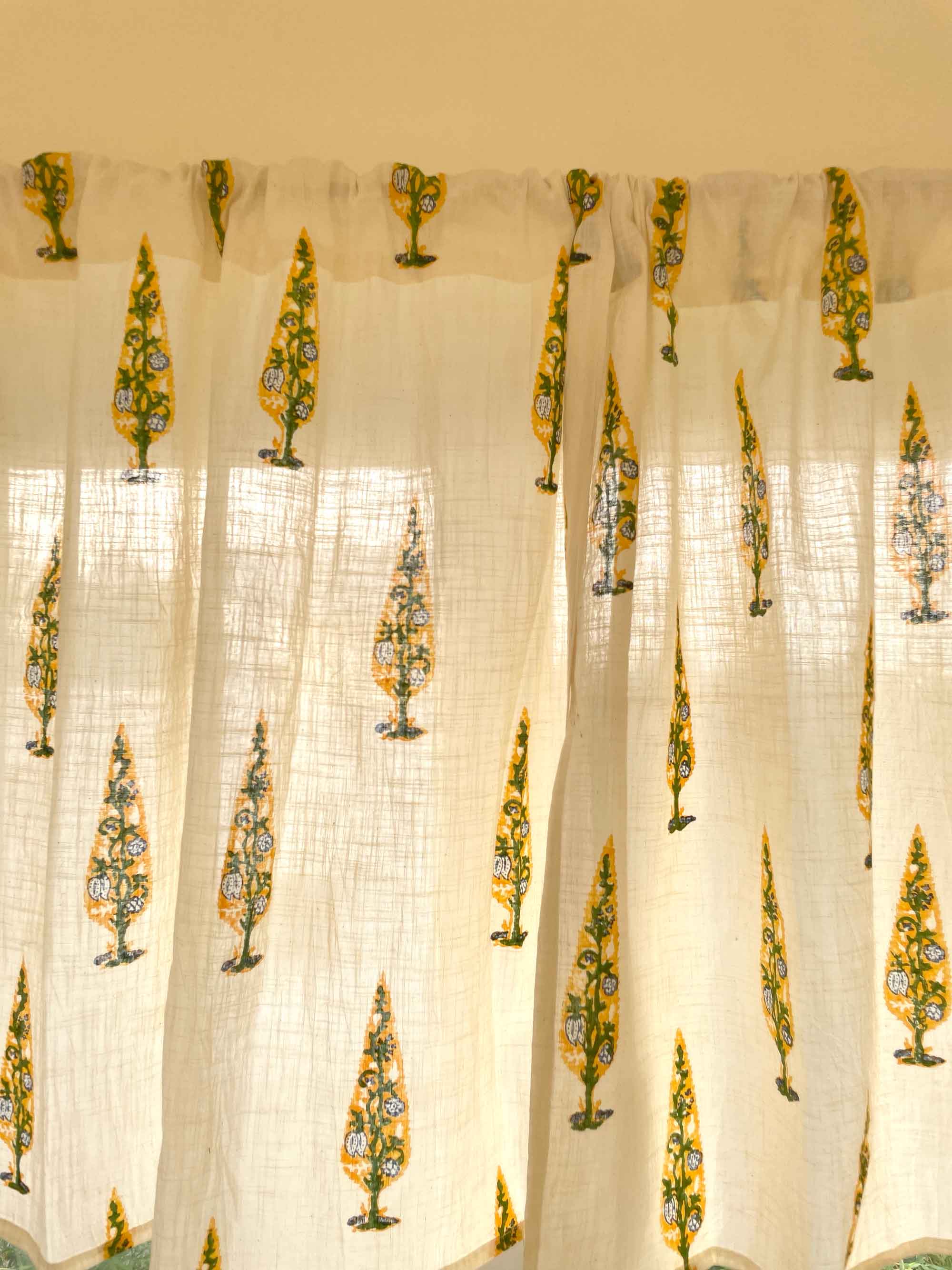 Sheer curtain with floral patterns in green and yellow on a beige background