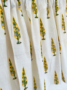 Close-up of white fabric with yellow and green floral patterns