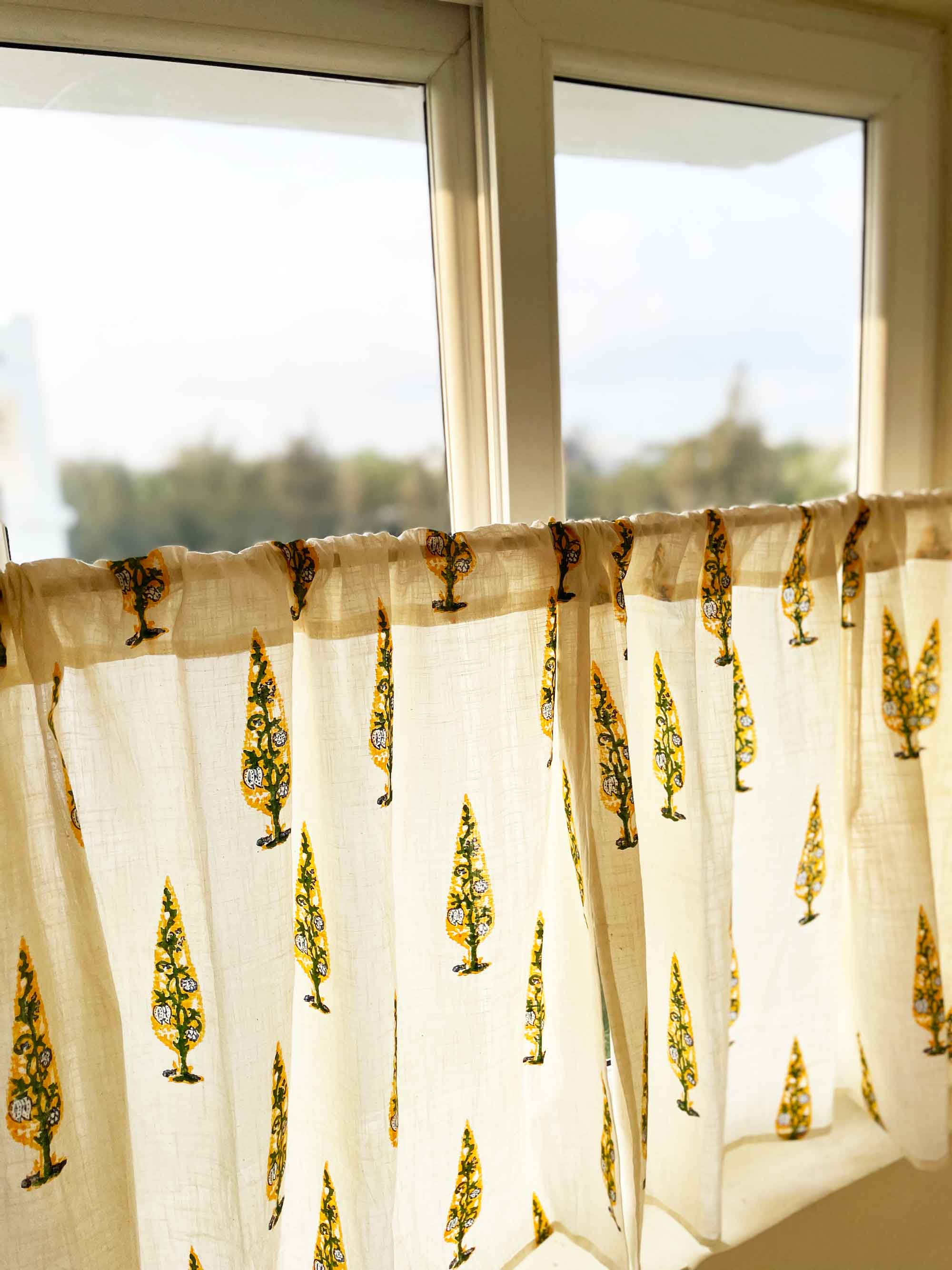 Sheer curtain with tree pattern in front of a window